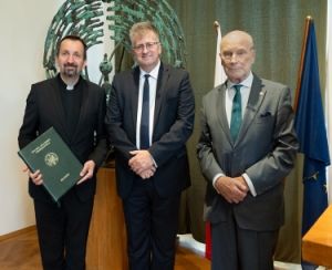 fotografa postaci stojących: od lewej ks. prof. dr. hab. Paweł Zając OMI, prof. dr hab. Mariusz Wołos, prof. dr hab. Jan K. Ostrowski